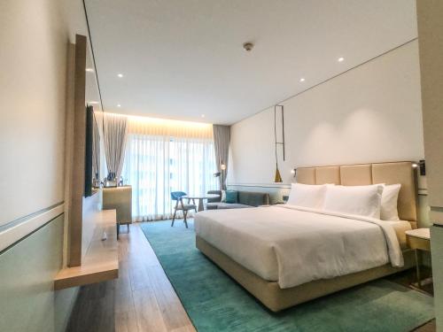 a hotel room with a bed and a living room at Radisson Blu Mumbai International Airport in Mumbai