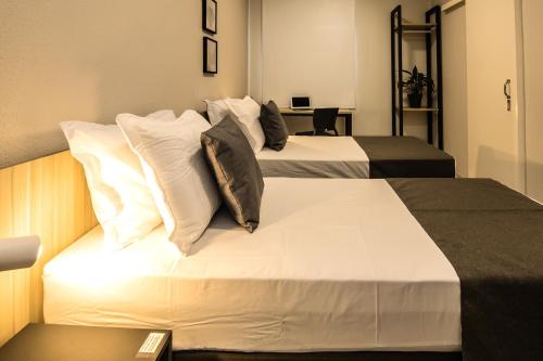 Säng eller sängar i ett rum på Hotel Santa Cruz