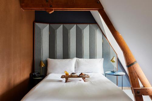 a bed with two teddy bears on top of it at Hotel Indigo The Hague - Palace Noordeinde, an IHG Hotel in The Hague