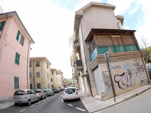 eine Straße mit Autos auf der Seite eines Gebäudes mit Graffiti in der Unterkunft Oasi 83 in San Benedetto del Tronto