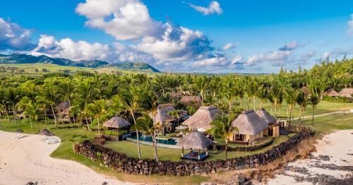 an aerial view of a resort with palm trees at Shanti Maurice Resort & Spa in Bel Ombre