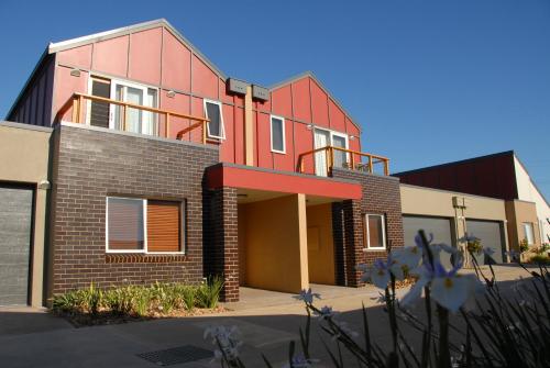 a brick building with a red roof at The Lakes Apartments in Lakes Entrance