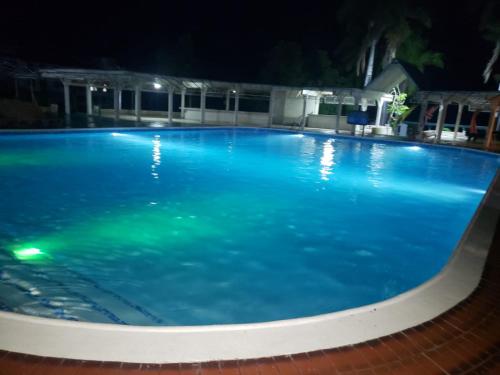 a large blue swimming pool at night at Seacastle Deluxe Studio in Montego Bay