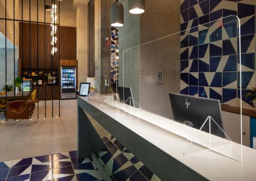 a lobby with a counter with a laptop on it at Hotel Indigo Miami Brickell, an IHG Hotel in Miami