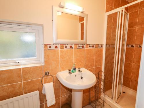 a bathroom with a sink and a mirror at The Admiral in Coleraine