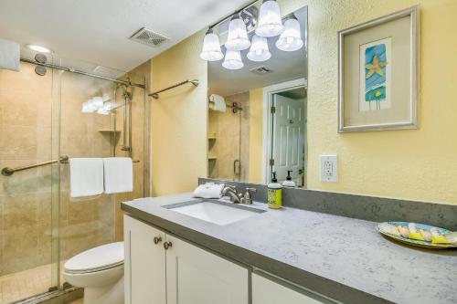 a bathroom with a sink and a toilet and a mirror at Aqua Vista in Tavernier