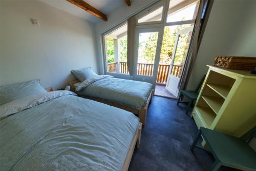 En eller flere senge i et værelse på Vakantiehuis Le Platane - in natuurgebied nabij Nijmegen