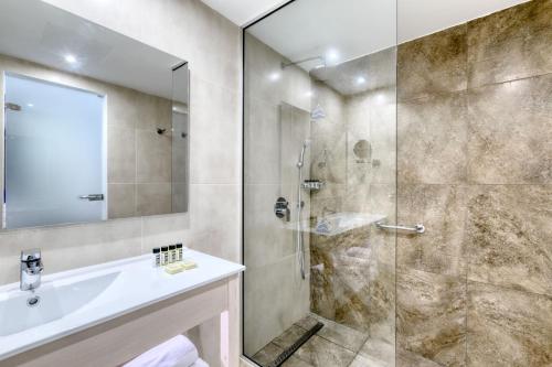 a bathroom with a shower and a sink at Atlantica SunGarden Beach in Ayia Napa
