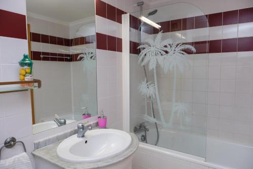 a bathroom with a sink and a shower and a tub at Summer in Paradise - Sea View and Pool in Ericeira in Ericeira