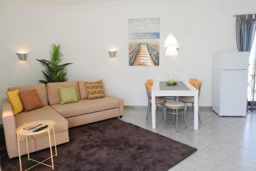 a living room with a couch and a table at Summer in Paradise - Sea View and Pool in Ericeira in Ericeira