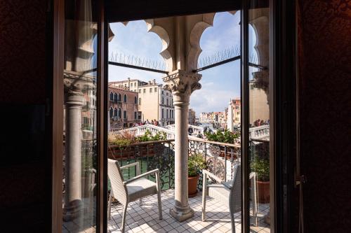 a balcony with a chair and a view of a city at Palazzina Veneziana in Venice
