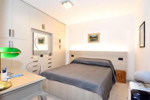 a small bedroom with a bed and a desk at Bellagio Pescallo Guesthouse in Bellagio