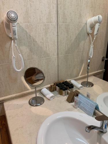 a bathroom with a sink and a phone on the wall at Katarino Mountain House in Razlog