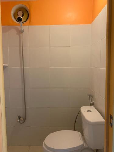 a small bathroom with a toilet and a shower at Perlies Inn Studio House with NETFLIX in Tanay