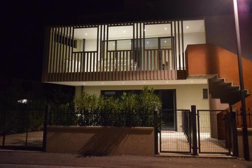 a house with a fence in front of it at night at Villa Alcova in Caorle