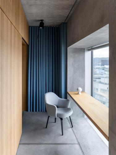 a white chair in a room with a window at Placid Hotel Design & Lifestyle Zurich in Zürich