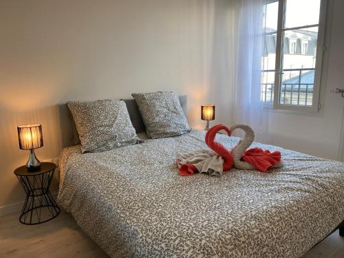 a bedroom with a bed with two stuffed animals on it at Douillet BY DREAM APARTMENTS in Serris