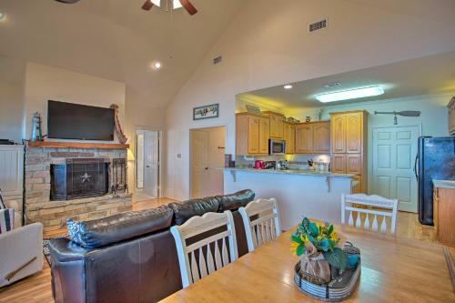 a living room and kitchen with a couch and a fireplace at Private Dock and Fire Pit Cedar Creek Lake Home in Eustace