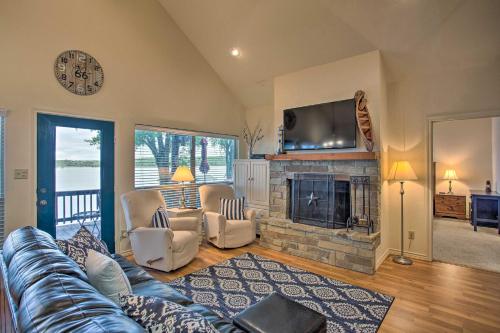 a living room with a couch and a fireplace at Private Dock and Fire Pit Cedar Creek Lake Home in Eustace