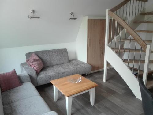 a living room with a couch and a table at Finnhütte Bernstein in Gager