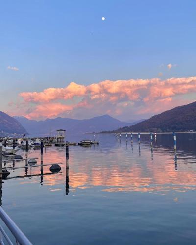 a large body of water with a pier and mountains at Sarnico Terrazza sul lago di Iseo in Sarnico