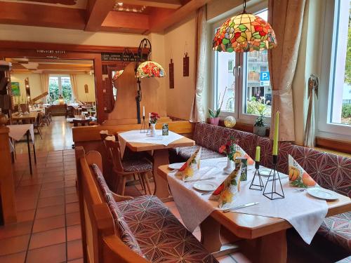 a restaurant with tables and chairs in a room at Hotel Neuenburger Hof in Neuenburg am Rhein