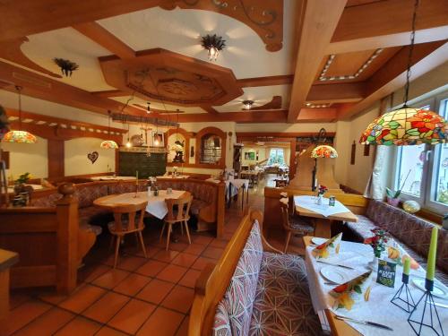 a restaurant with tables and chairs in a room at Hotel Neuenburger Hof in Neuenburg am Rhein