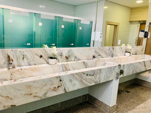 a marble bathroom with two sinks and a large mirror at TRYP by Wyndham Manaus Aeroporto in Manaus