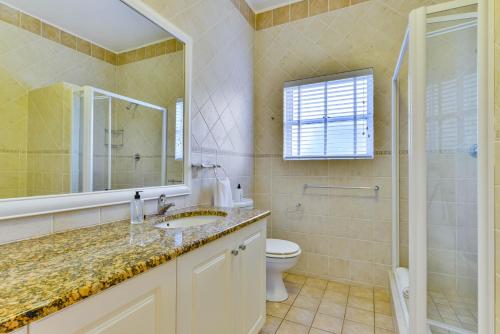 a bathroom with a sink and a toilet and a mirror at Plettenberg View in Plettenberg Bay