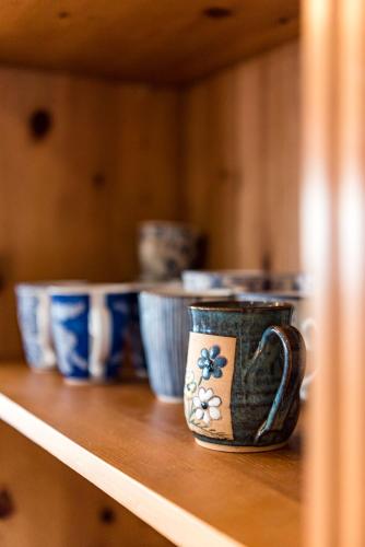 a shelf with several cups sitting on top of it at Plettenberg View in Plettenberg Bay