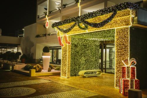 a lit up house with christmas lights and presents at Mec Paestum Hotel in Paestum