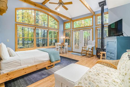 a living room with a bed and a tv at Saltbox in Thompsonville