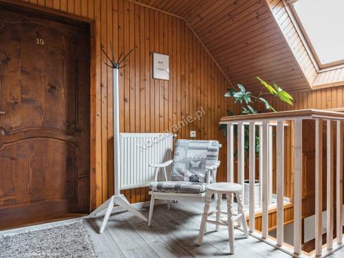 a room with a rocking chair and a door at Penzion u Laca in Zuberec