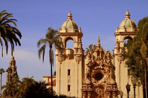 a building with two towers and a palm tree at Hotel Indigo San Diego - Gaslamp Quarter by IHG in San Diego