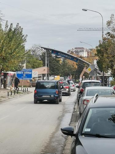 a busy street with cars parked at a gas station at STAN na DAN PEX FREE PARKING in Vranje