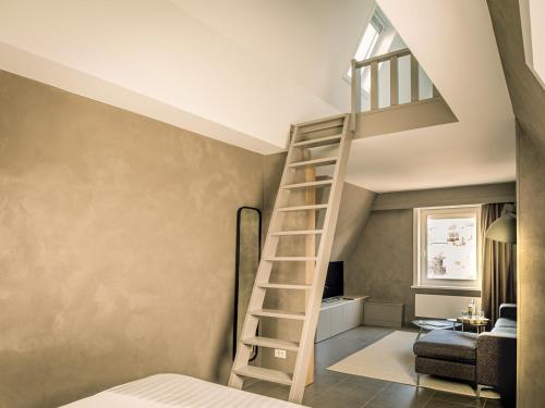 a bedroom with a loft bed and a ladder in a room at Apart! & Moment! in De Haan