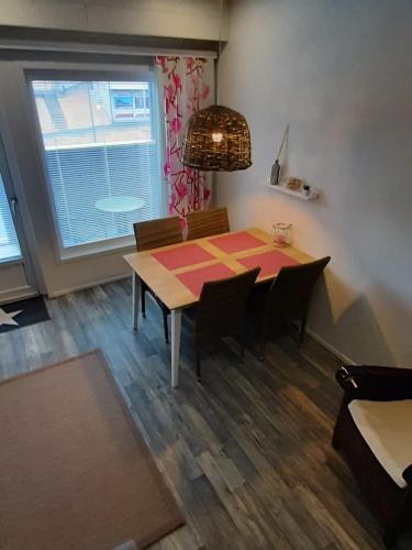 a dining room with a table and chairs and a window at Apartment Starvillas Kalajoki in Kalajoki