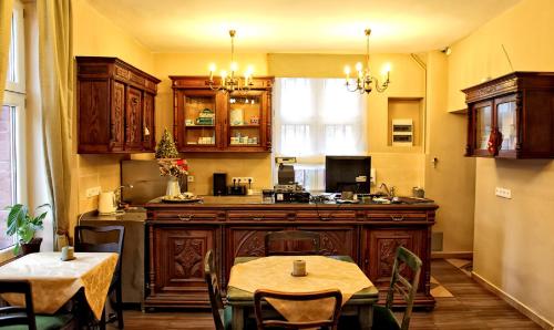 a kitchen with a table and a table and chairs at Green Hostel Wrocław przy ZOO in Wrocław