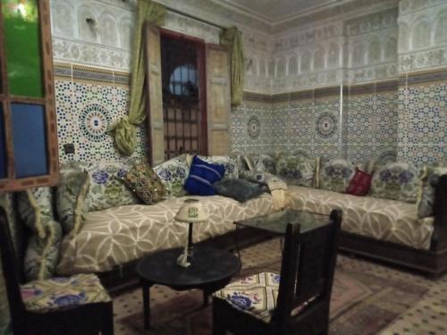 a living room with a couch and a table at Riad Selma in Meknès