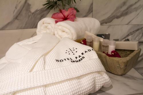 a bathroom with towels and other items on a counter at Hotel Parada Linares in Linares