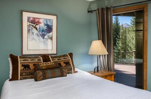 a bedroom with a bed and a door to a balcony at Heartstone Hideaway in Breckenridge