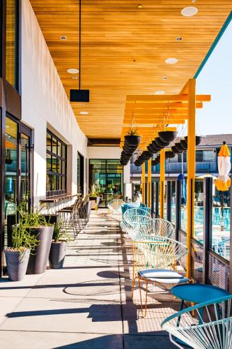 a patio with chairs and tables on a building at voco The Tuxon by IHG in Tucson