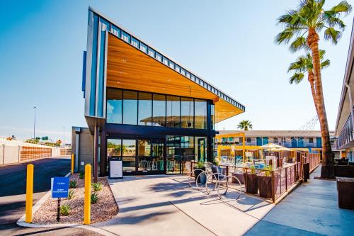 a building with a palm tree in front of it at voco The Tuxon by IHG in Tucson