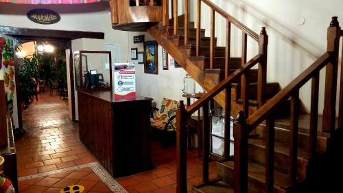 a hallway with a staircase in a room with a table at Posada Papa Chepe in La Esperanza
