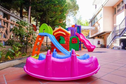 a plastic playground with a slide on a sidewalk at Hotel Tridentum in Cesenatico