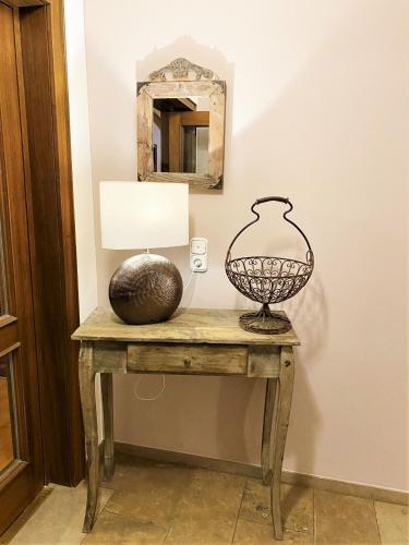 a table with a lamp and a mirror on it at Hotel garni Bellevue in Bad Füssing