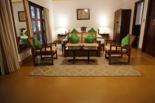 a living room with a table and two chairs at Saraca Hotel Lucknow in Lucknow