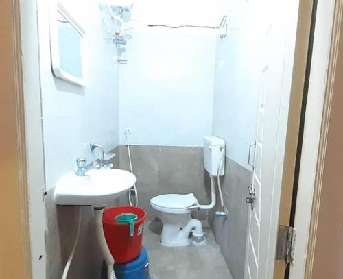 a small bathroom with a toilet and a sink at PPH Living SS Grand in Shamshabad