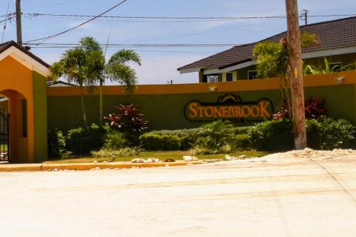 a store with a sign on the side of a building at L&V Paradise Vacation Home with Pool and Gym in Falmouth