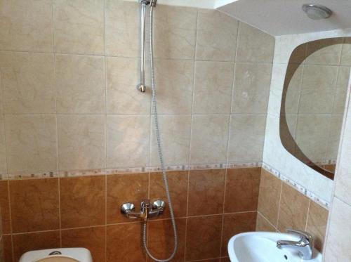 a shower in a bathroom with a toilet and a sink at Guest Rooms Toni & Miro in Tryavna